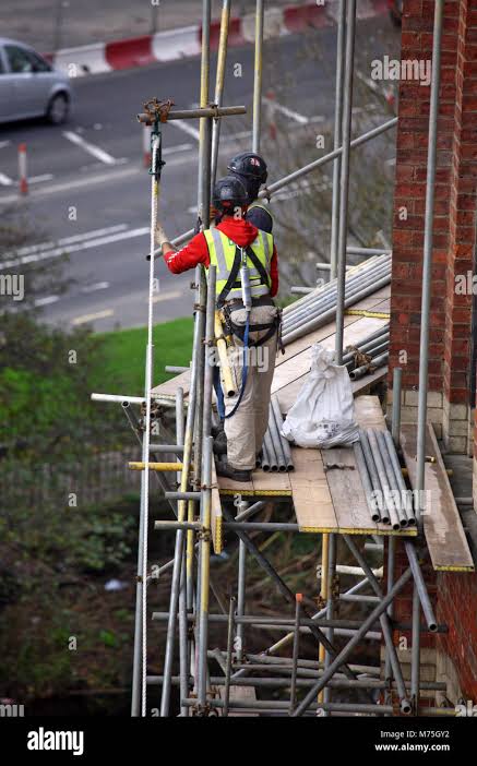 Scaffolders working safely on a construction site